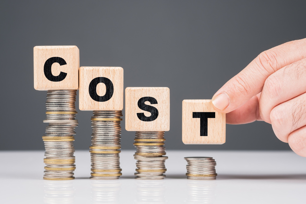 Stacked coins with wooden blocks spelling 'COST,' representing the financial impact of transformative SEO trends on businesses.