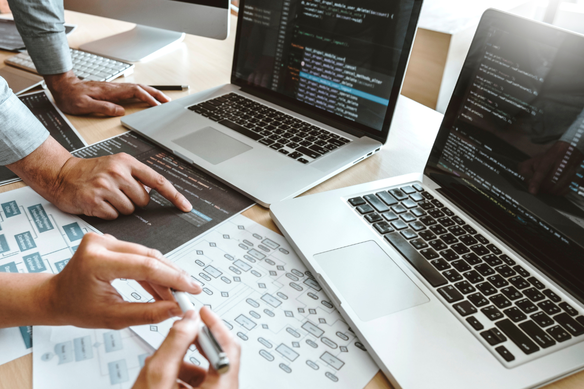 Two people working together on a computer, showcasing the collaboration between web developers and digital designers in the web design and development process, highlighting their teamwork in creating seamless, functional, and visually appealing websites.