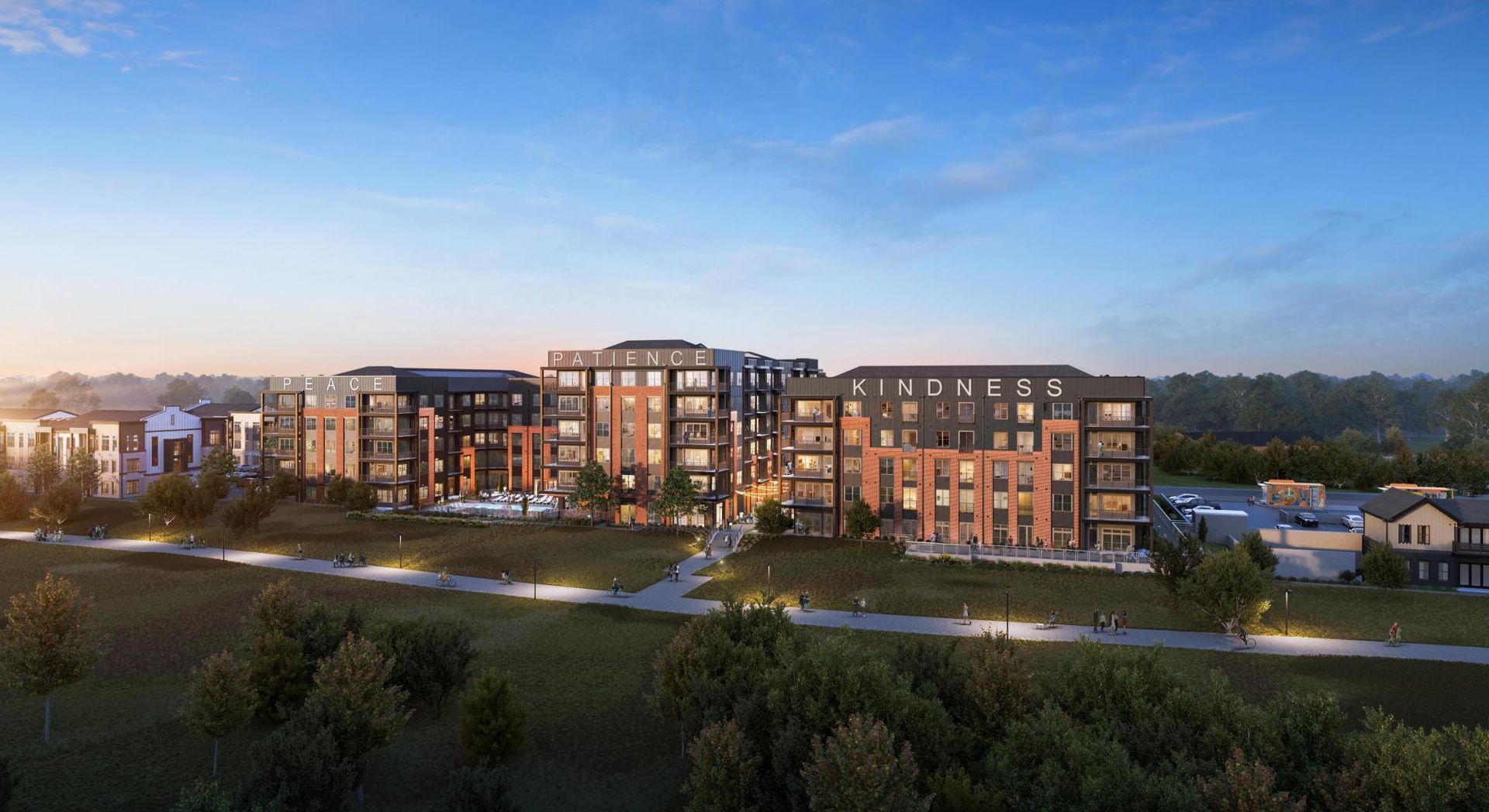 Modern apartment complex at dusk with warm lit windows, landscaped grounds, and a blue evening sky