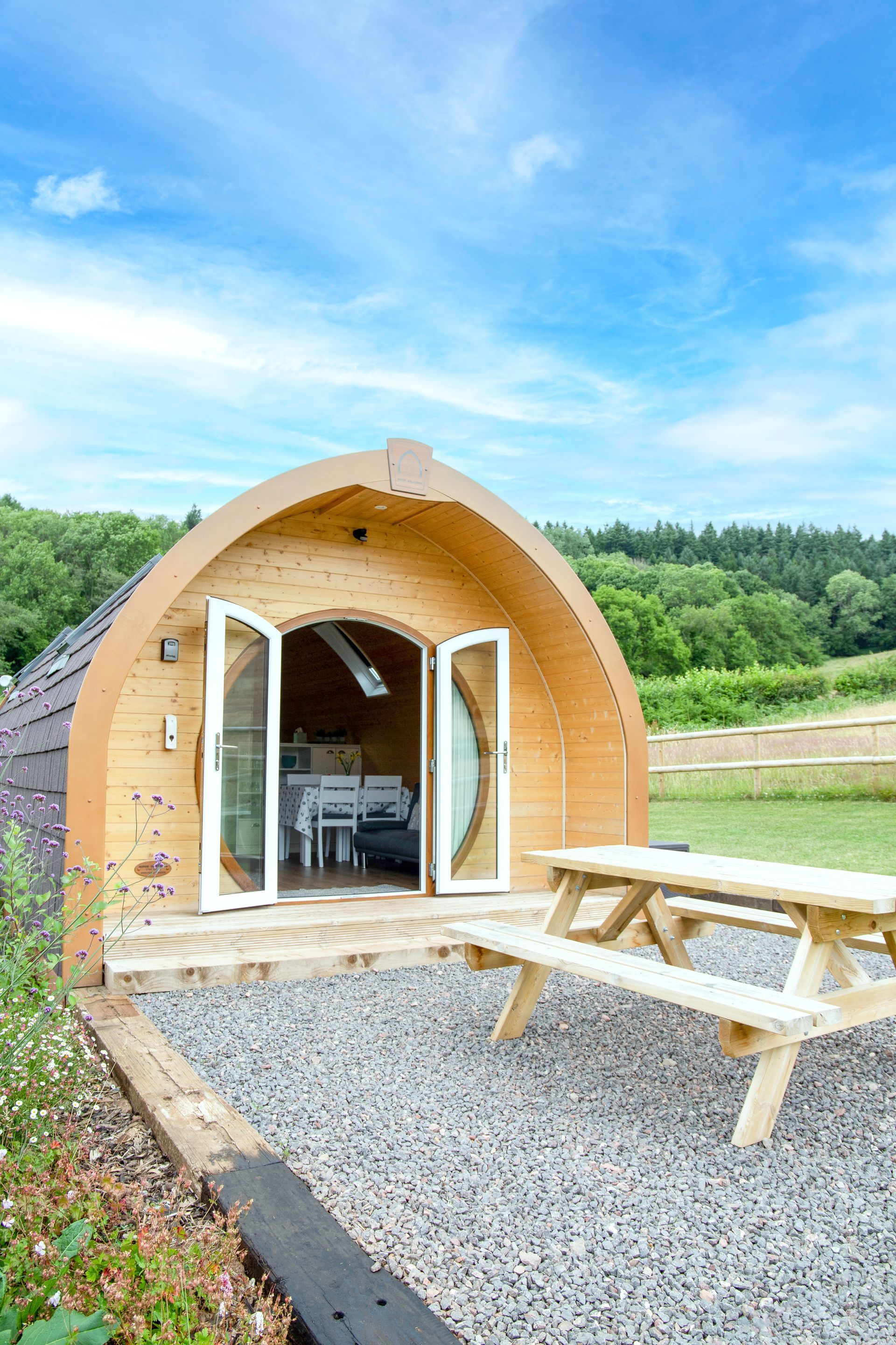 Luxury glamping pod in South Wales with outdoor seating area