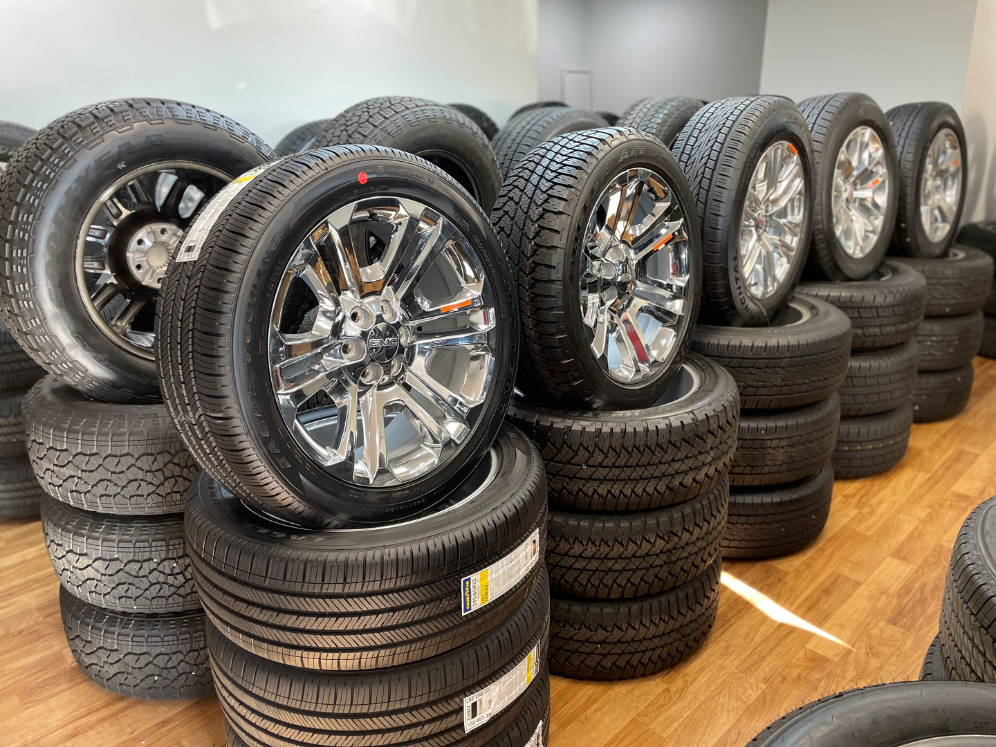 A bunch of tires are stacked on top of each other in a room.
