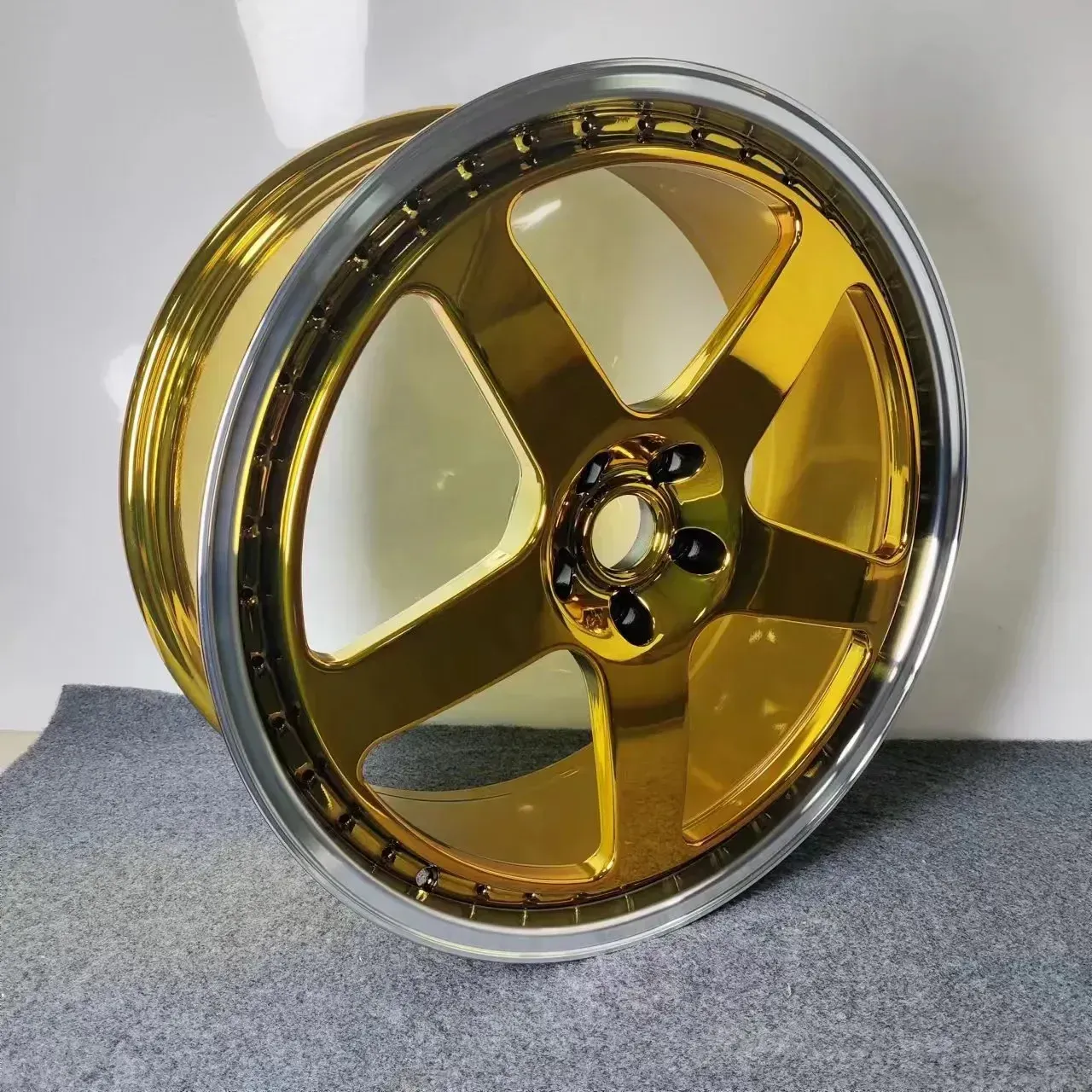 A close up of a gold wheel on a carpet