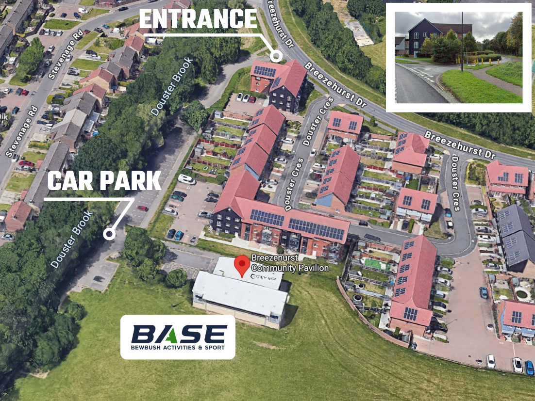 Aerial view of a base area with labeled entrance and car park, buildings, and a road.