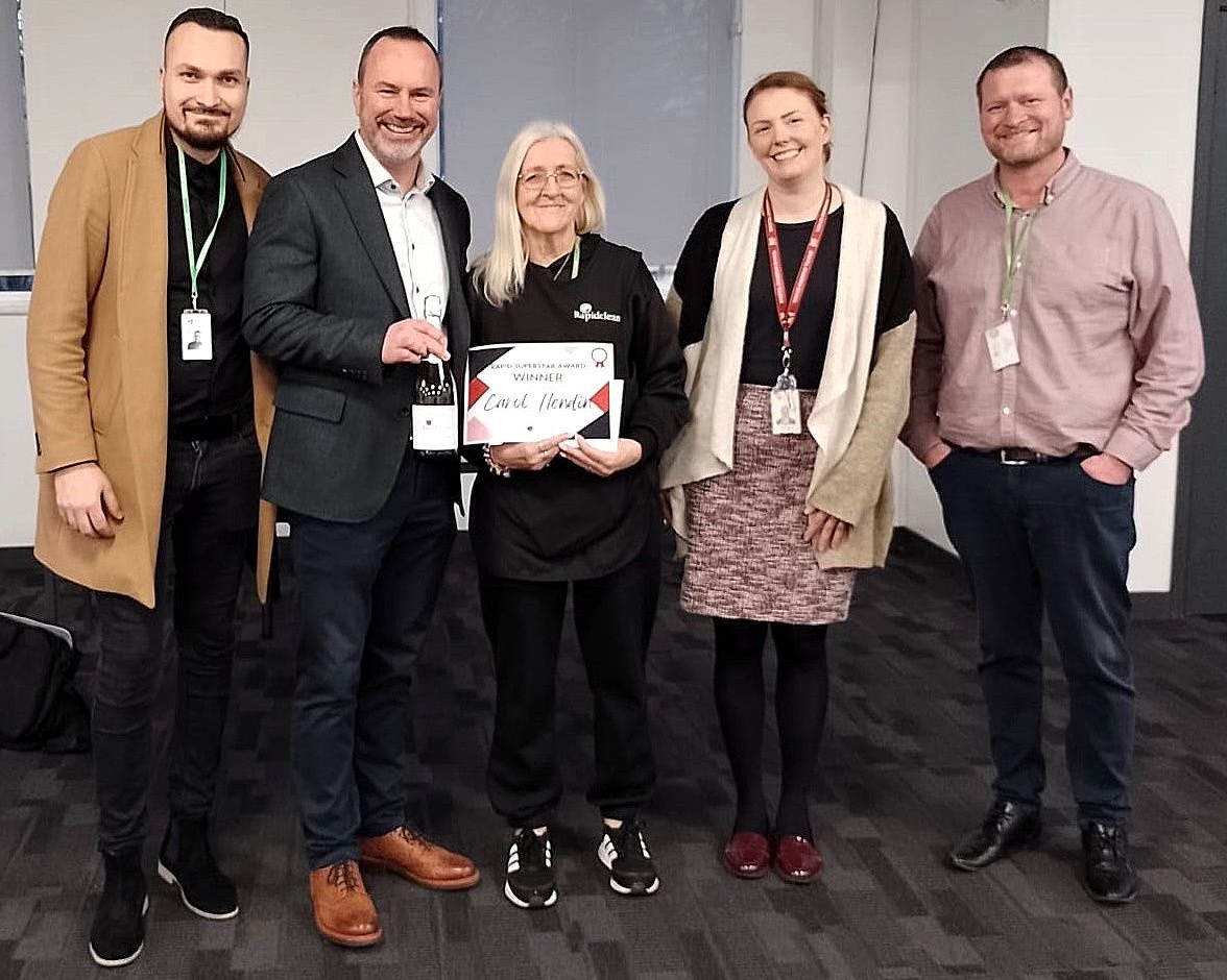 A group of people standing next to each other holding a certificate.