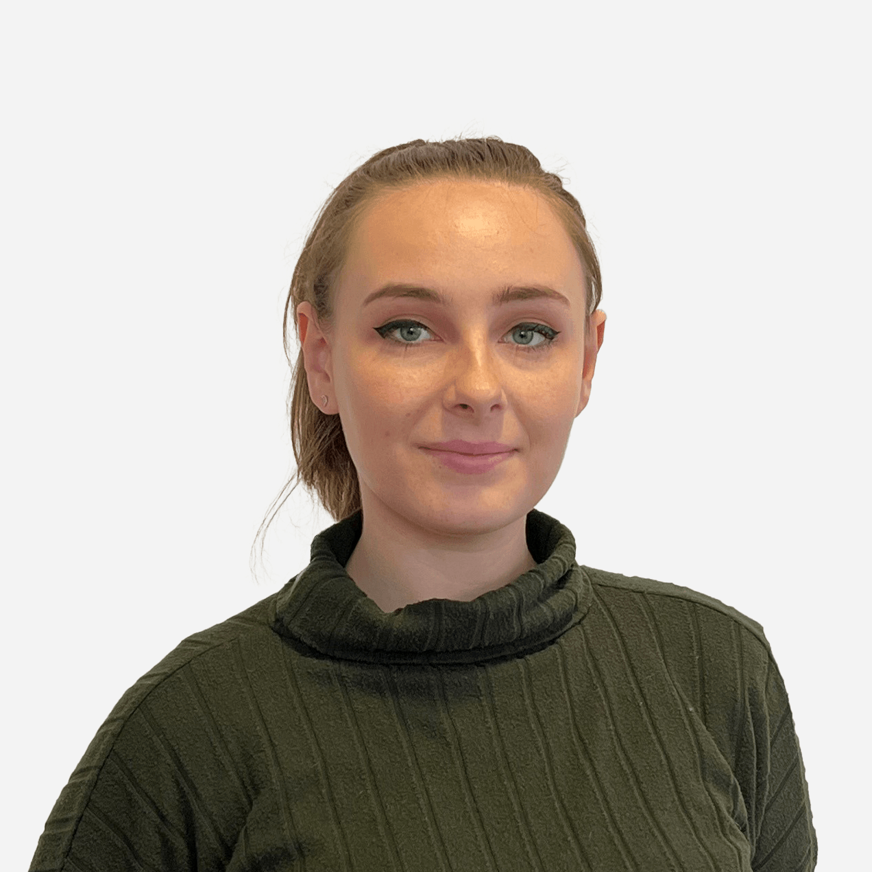 A woman in a green sweater is smiling for the camera.