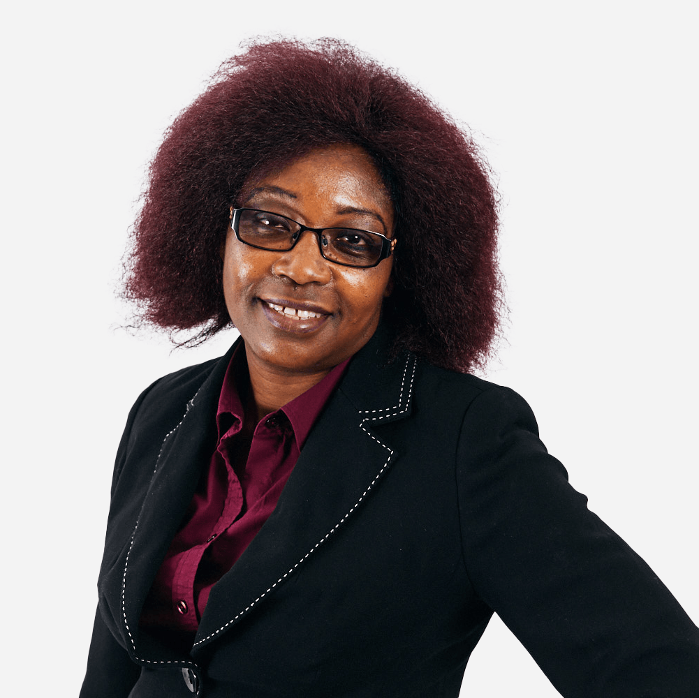 A woman with red hair wearing glasses and a black jacket
