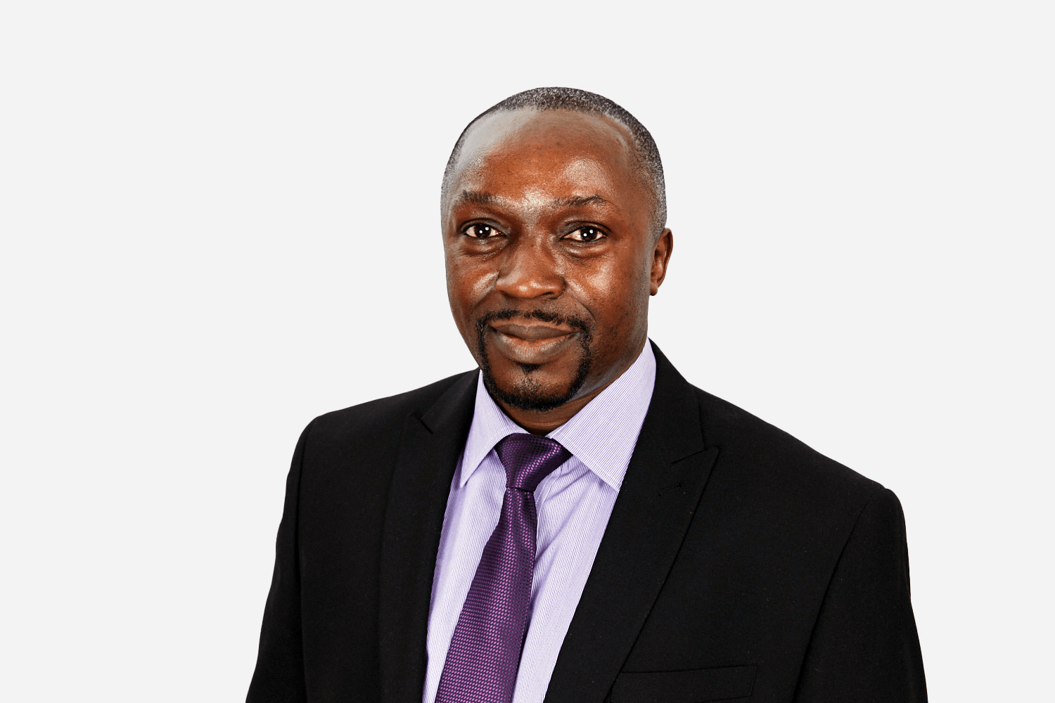 A man in a suit and tie is smiling for the camera.