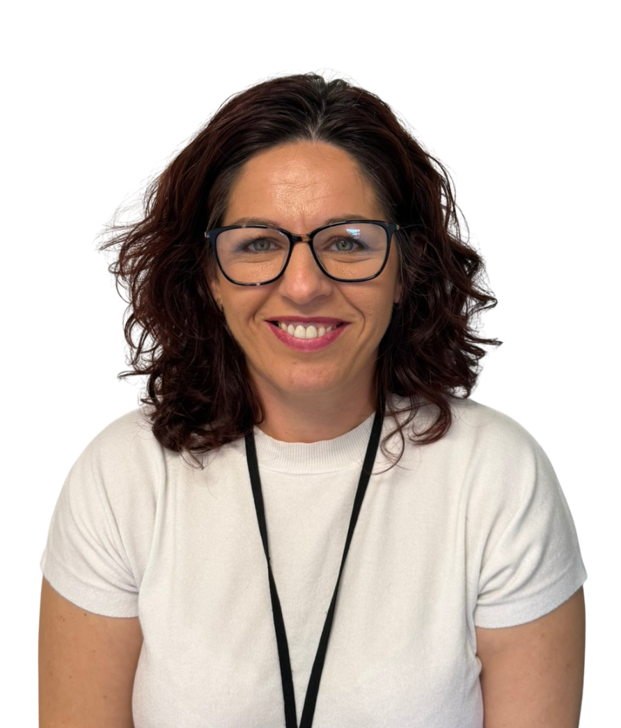 Smiling woman with glasses in a white blouse with small heart patterns, against a white background