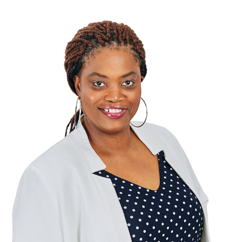 A woman in a white jacket and polka dot shirt is smiling for the camera.