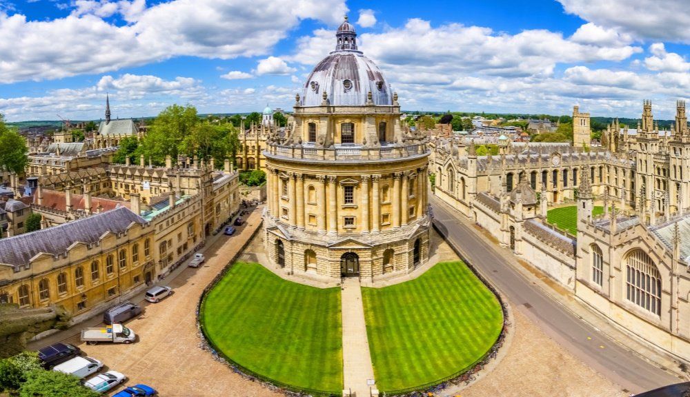 An aerial view of the university of oxford with a dome in the middle of the city.