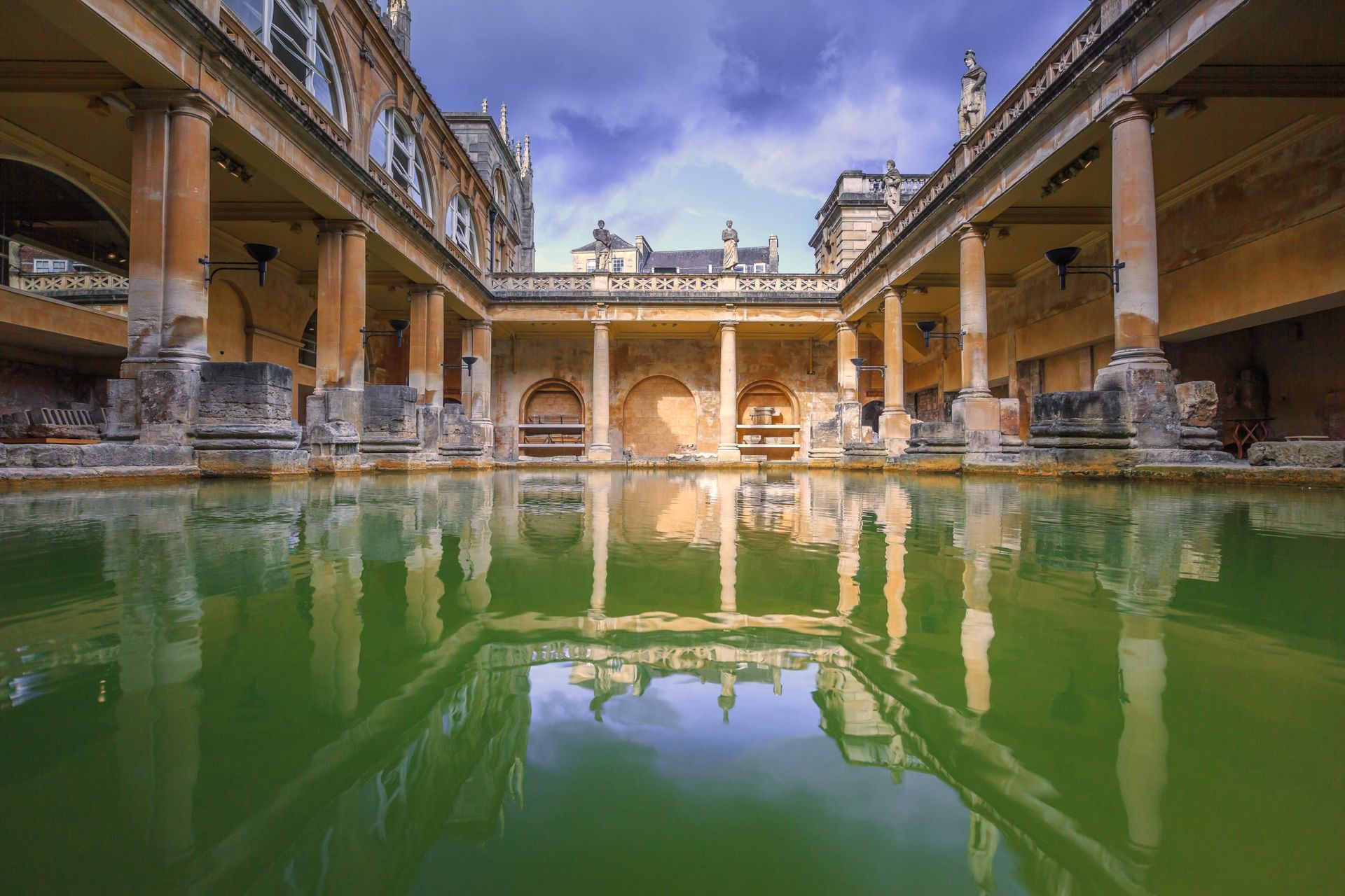 There is a large pool of water in the middle of a building.