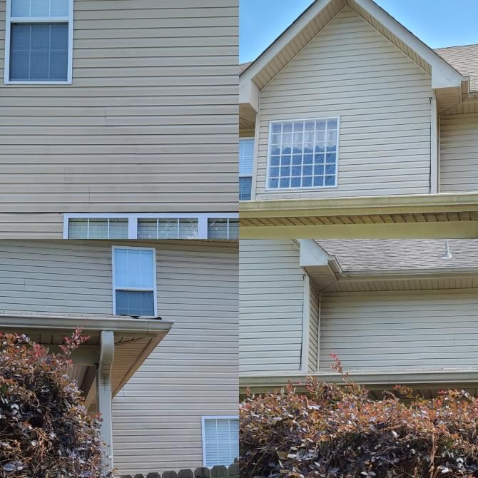 Exterior of a light beige two-story house with various windows, siding, and shrubs against a blue sky.