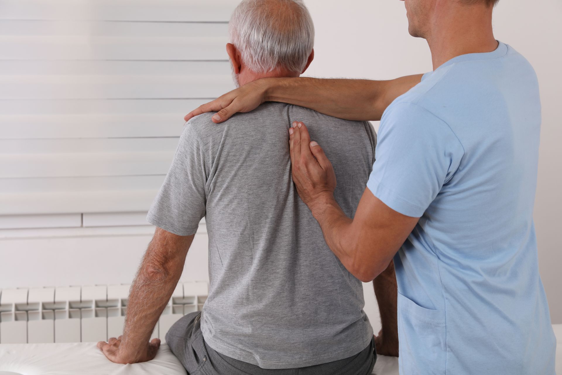 A chiropractor is performing a spinal assessment to improve posture and mobility.