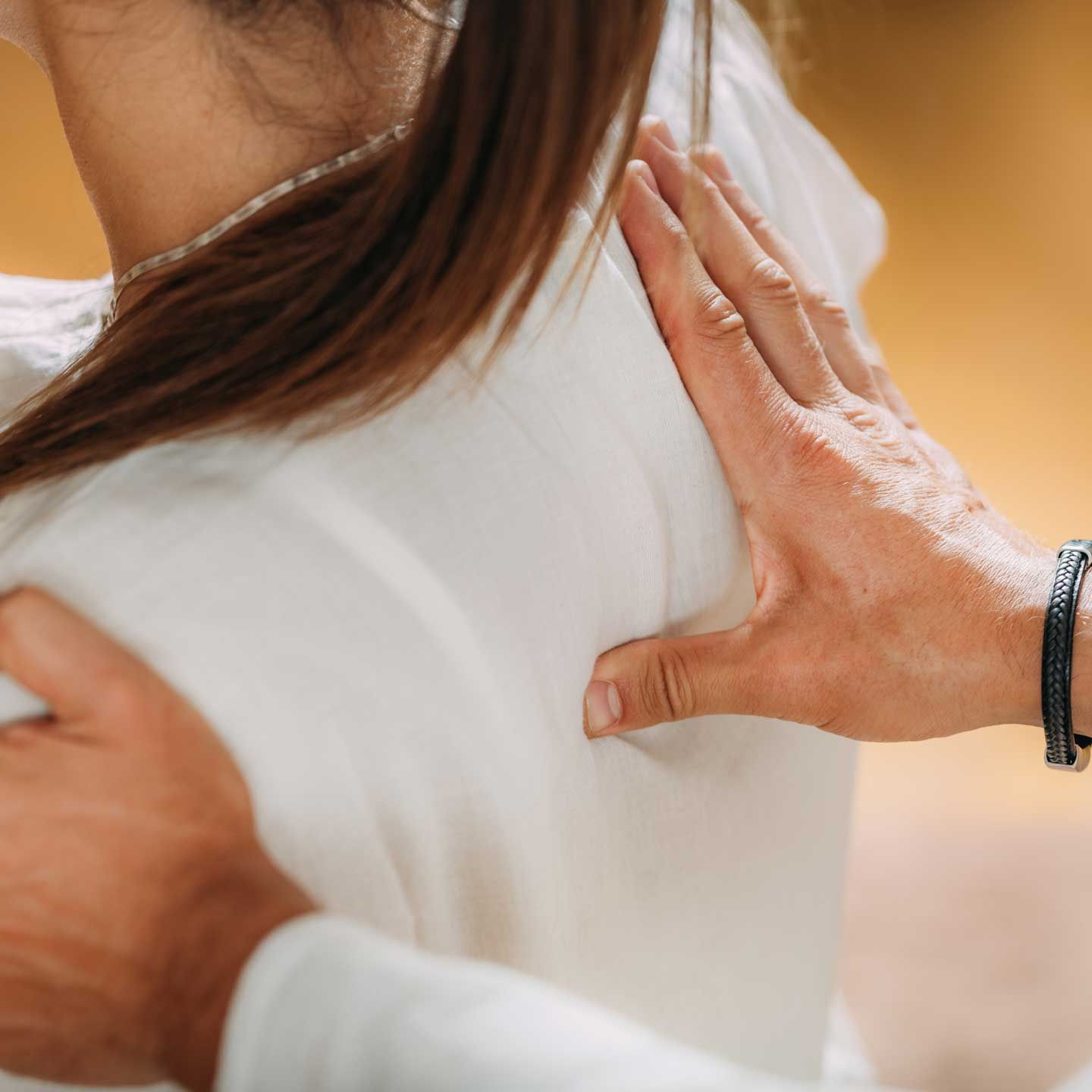 A person receiving a back massage or physical therapy adjustment from a practitioner.