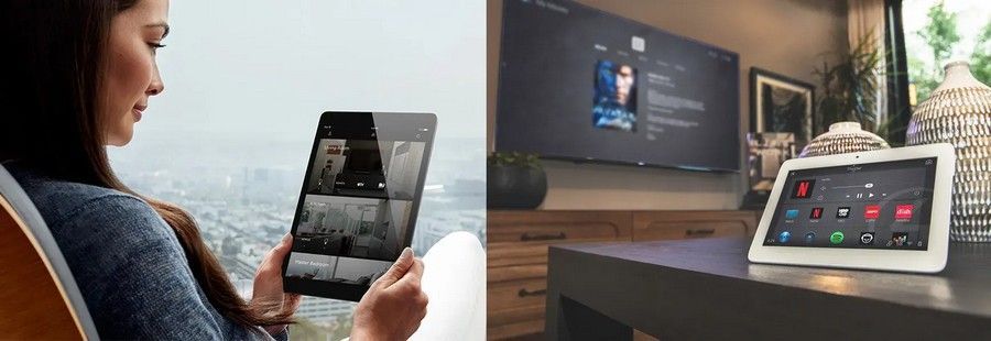 Woman using a tablet with a streaming video at home, beside a TV and another tablet on a desk