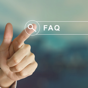 Hand touching a search icon next to “FAQ” on a blurred background