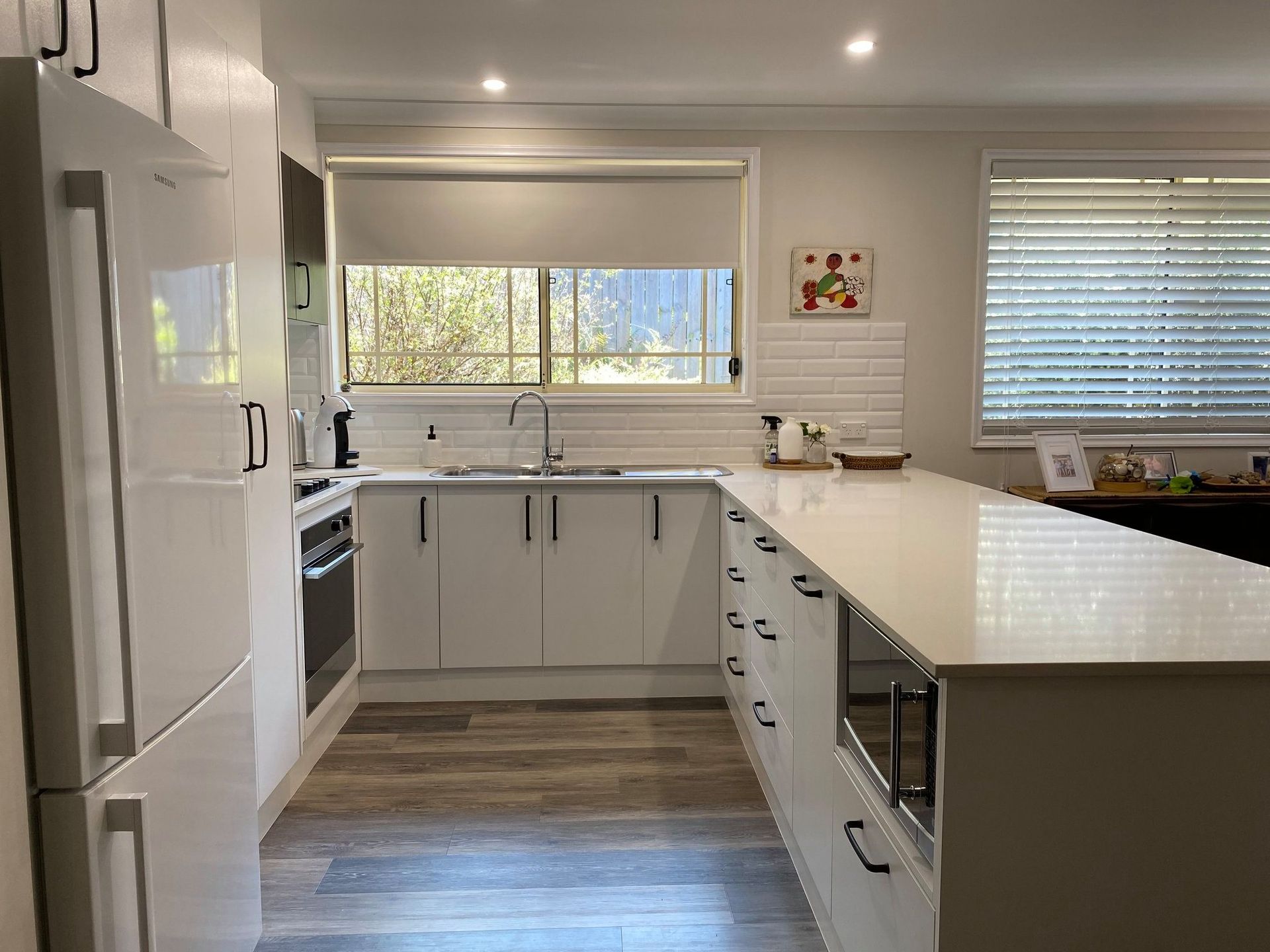 White Kitchen With Island, Cabinets, Oven, and Refrigerator — Trim Joinery In Hunter Valley, NSW