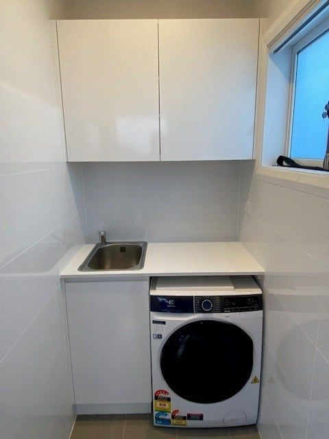 A Small Laundry Space With a White Sink Cabinet — Trim Joinery In Singleton, NSW