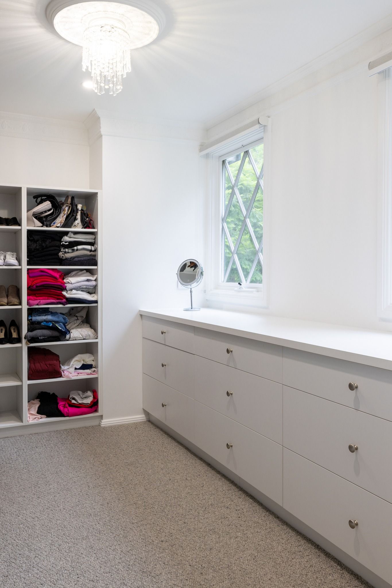 White Walk-in Closet With Shelves of Clothes and Drawers — Trim Joinery In Fountaindale, NSW