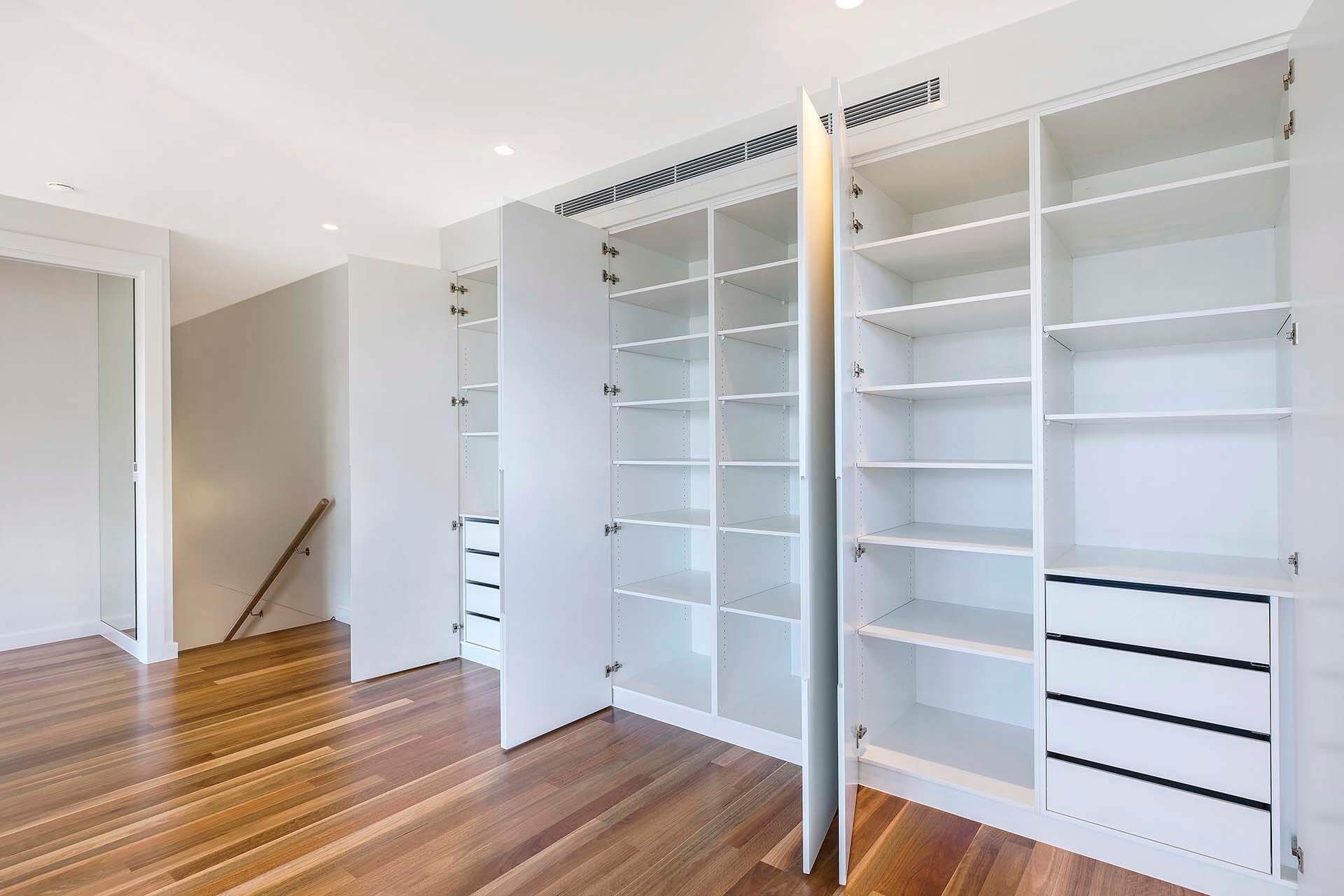 A Room Featuring Floor-to-ceiling Built-in Shelving Units — Trim Joinery In Fountaindale, NSW