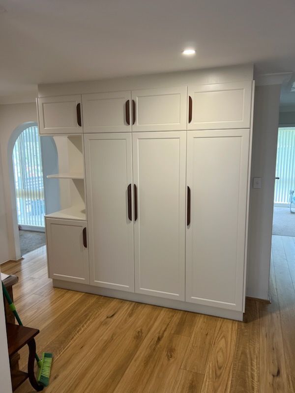 White Built-in Storage Cabinets With Dark Handles — Trim Joinery In Fountaindale, NSW