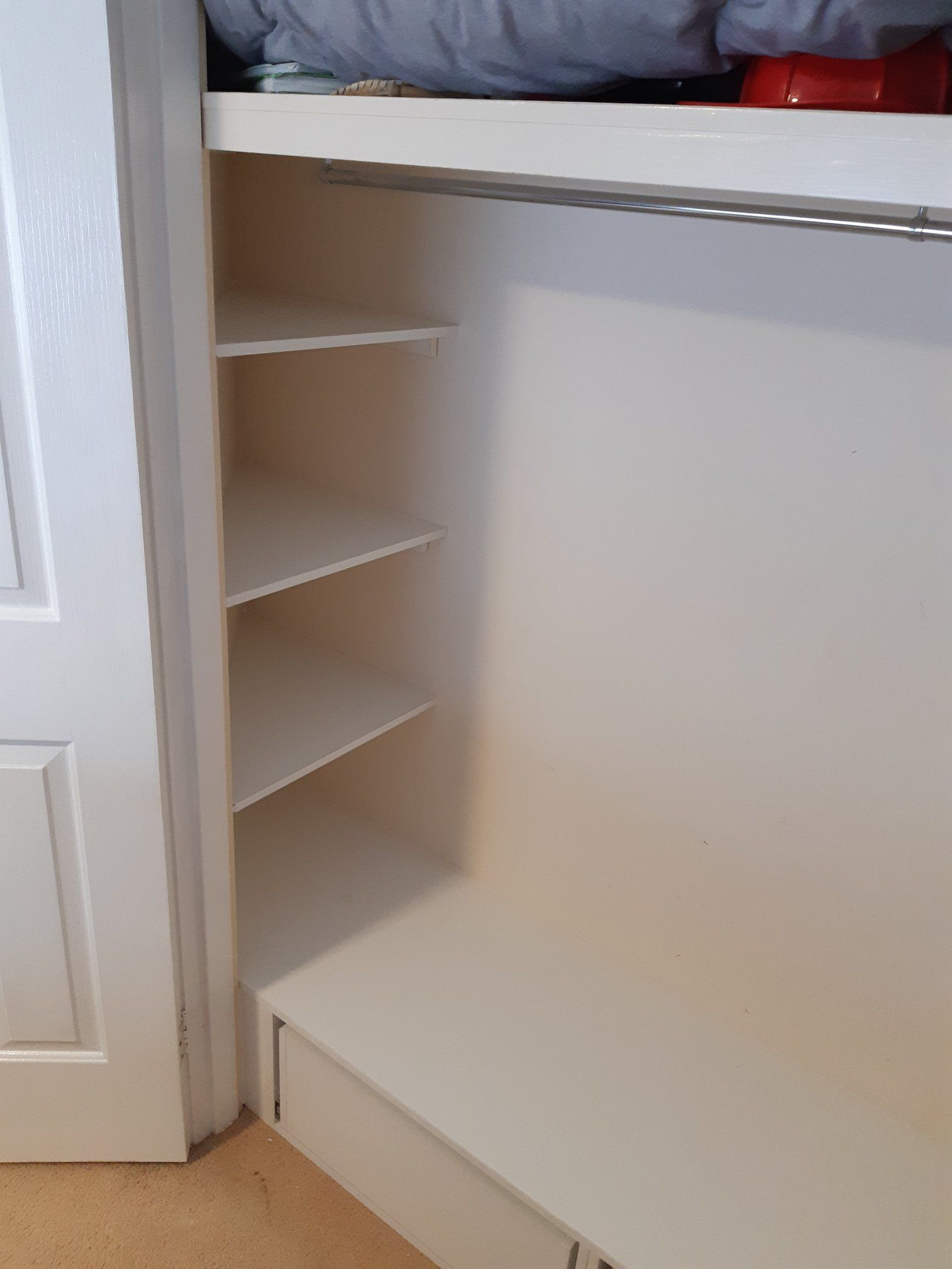White Closet Interior With Shelves on the Left and a Rod at the Top — Trim Joinery In Lake Macquarie, NSW