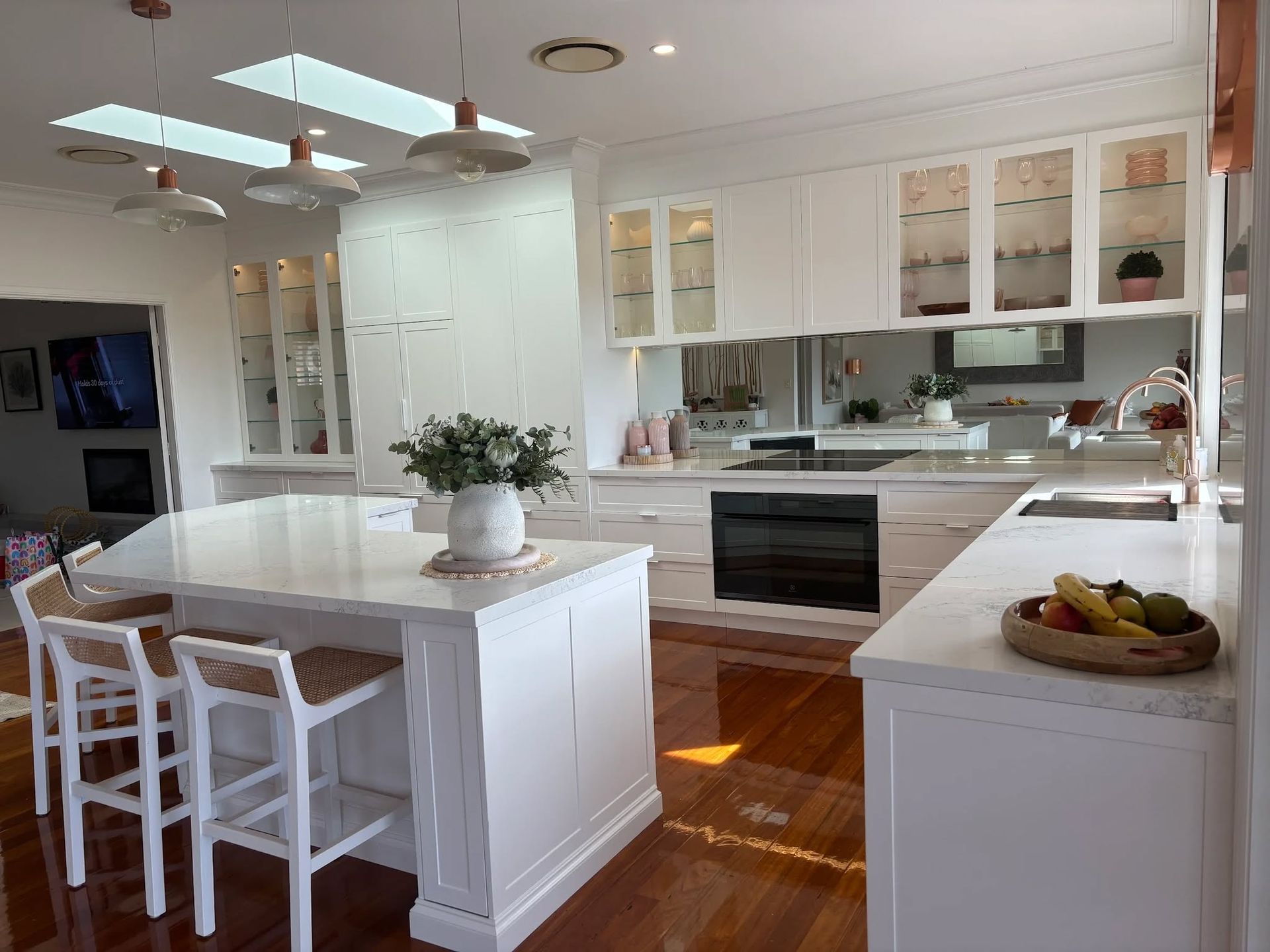 Kitchen With Island Seating, Glass-front Cabinets, and a Built-in Oven — Trim Joinery In Fountaindale, NSW