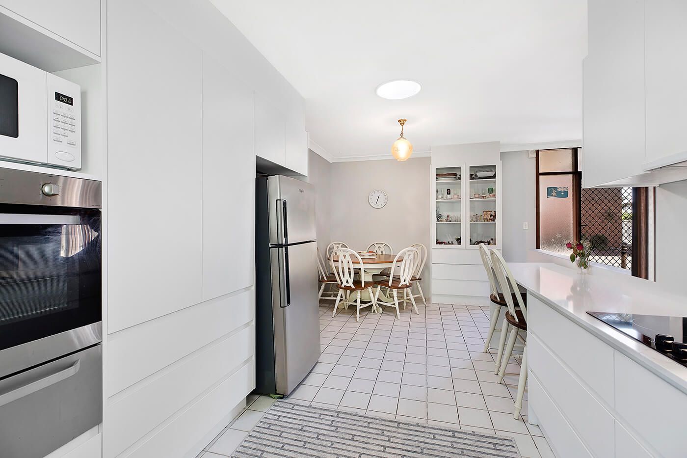 Modern White Kitchen With Stainless Steel Appliances — Trim Joinery In Fountaindale, NSW