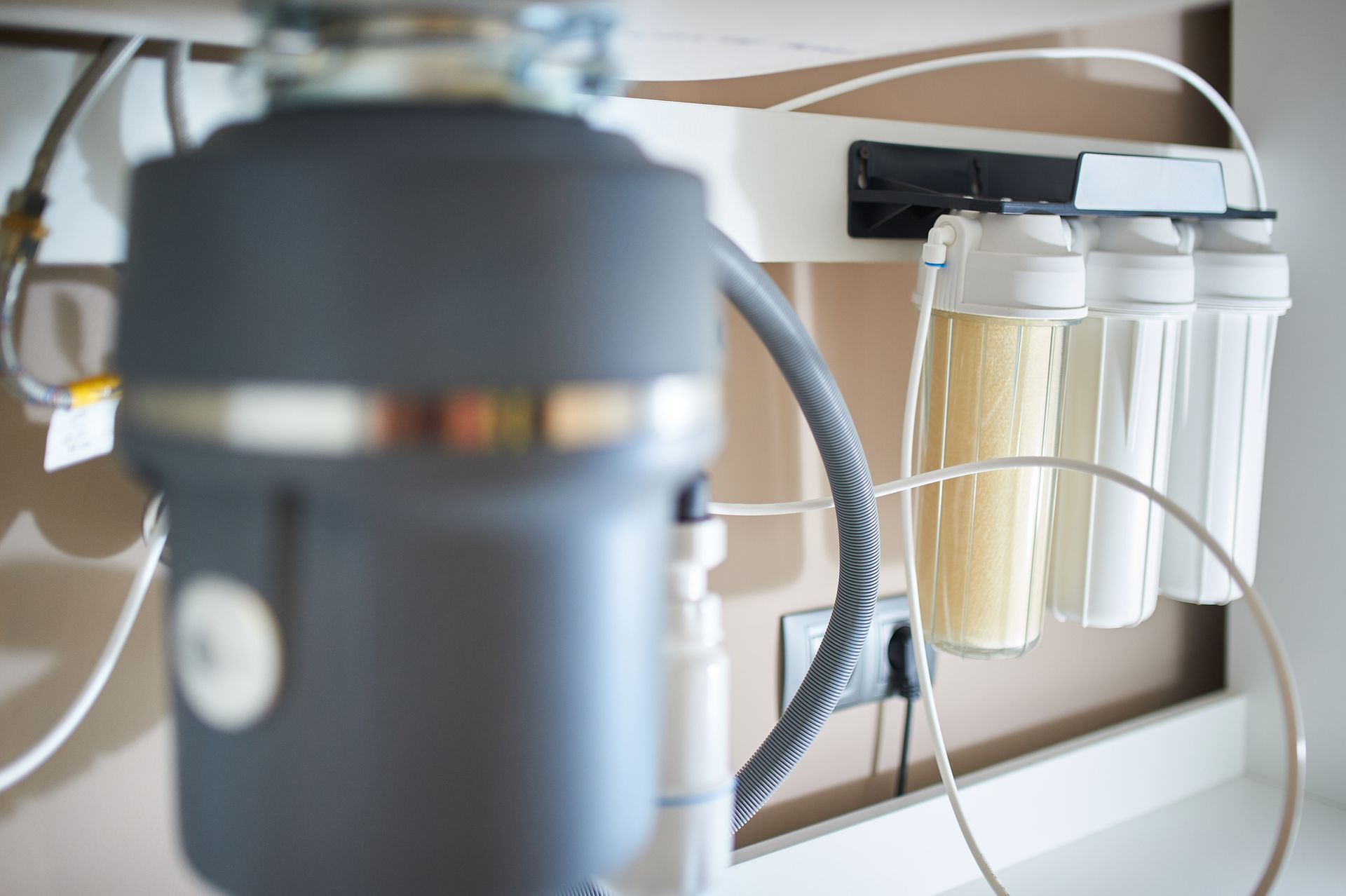 A kitchen sink with a water filter attached to it.