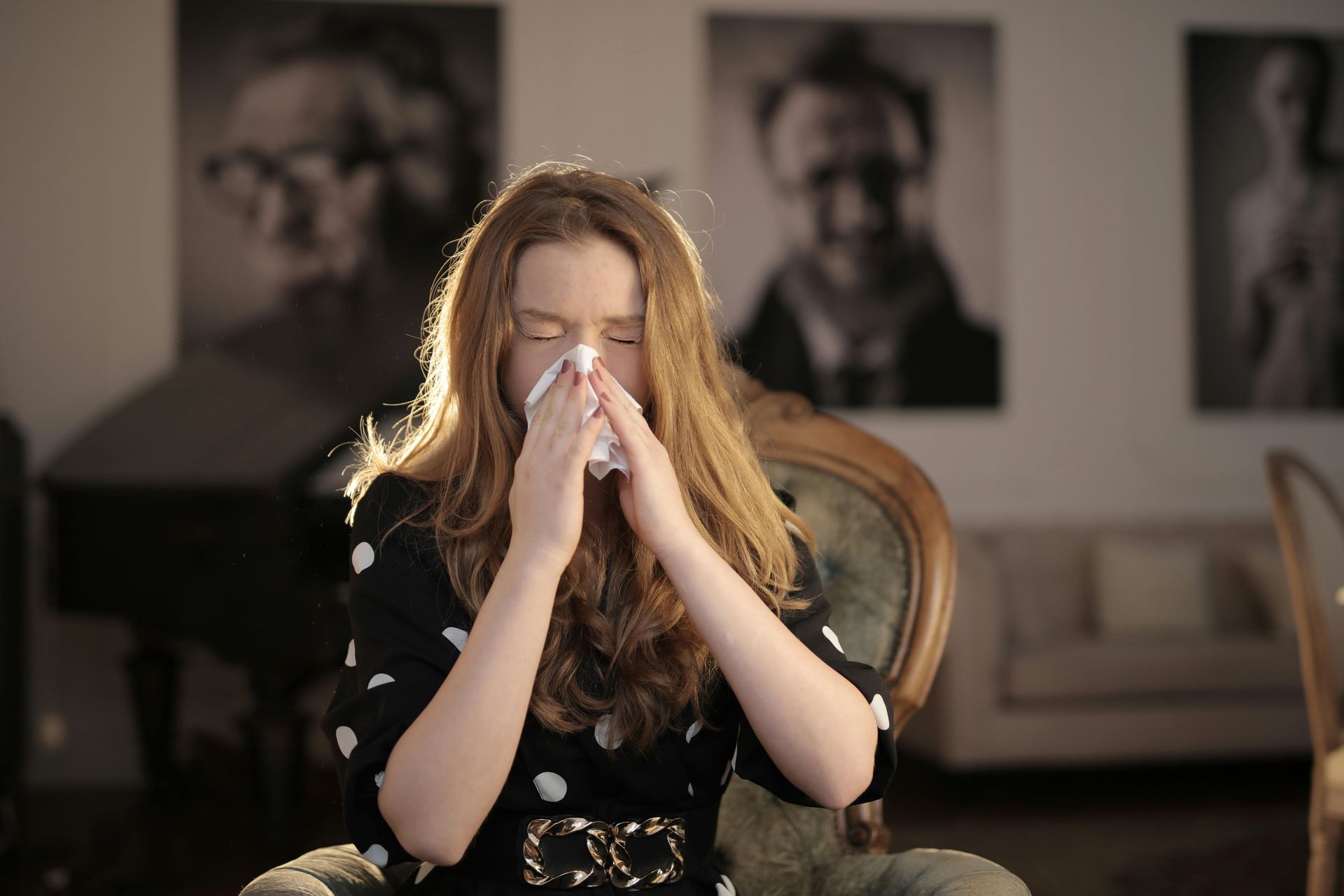 Girl Sneezing into a tissue