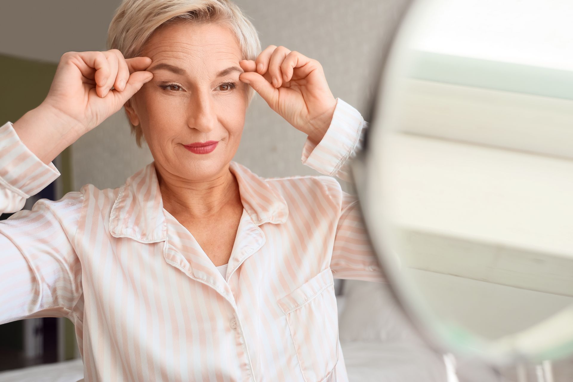 woman looking at her eyebrows