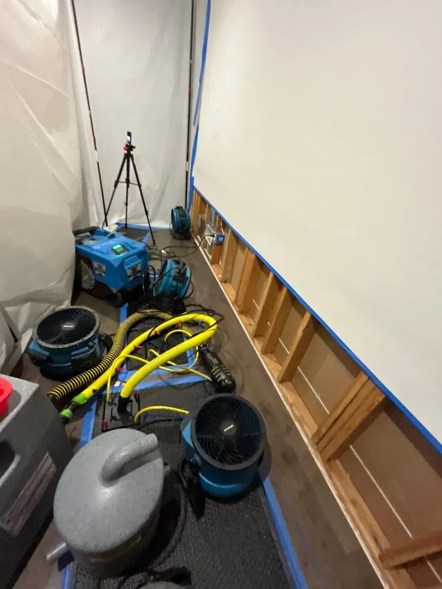 Howell, NJ hallway with lower wainscot panels removed and air movers drying the walls