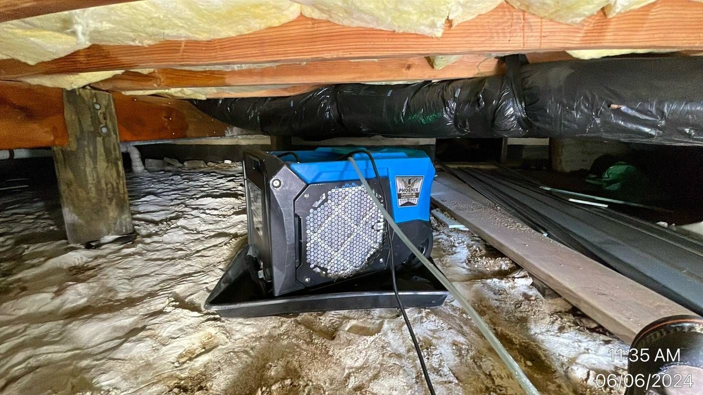 Dehumidifier drying a treated crawlspace