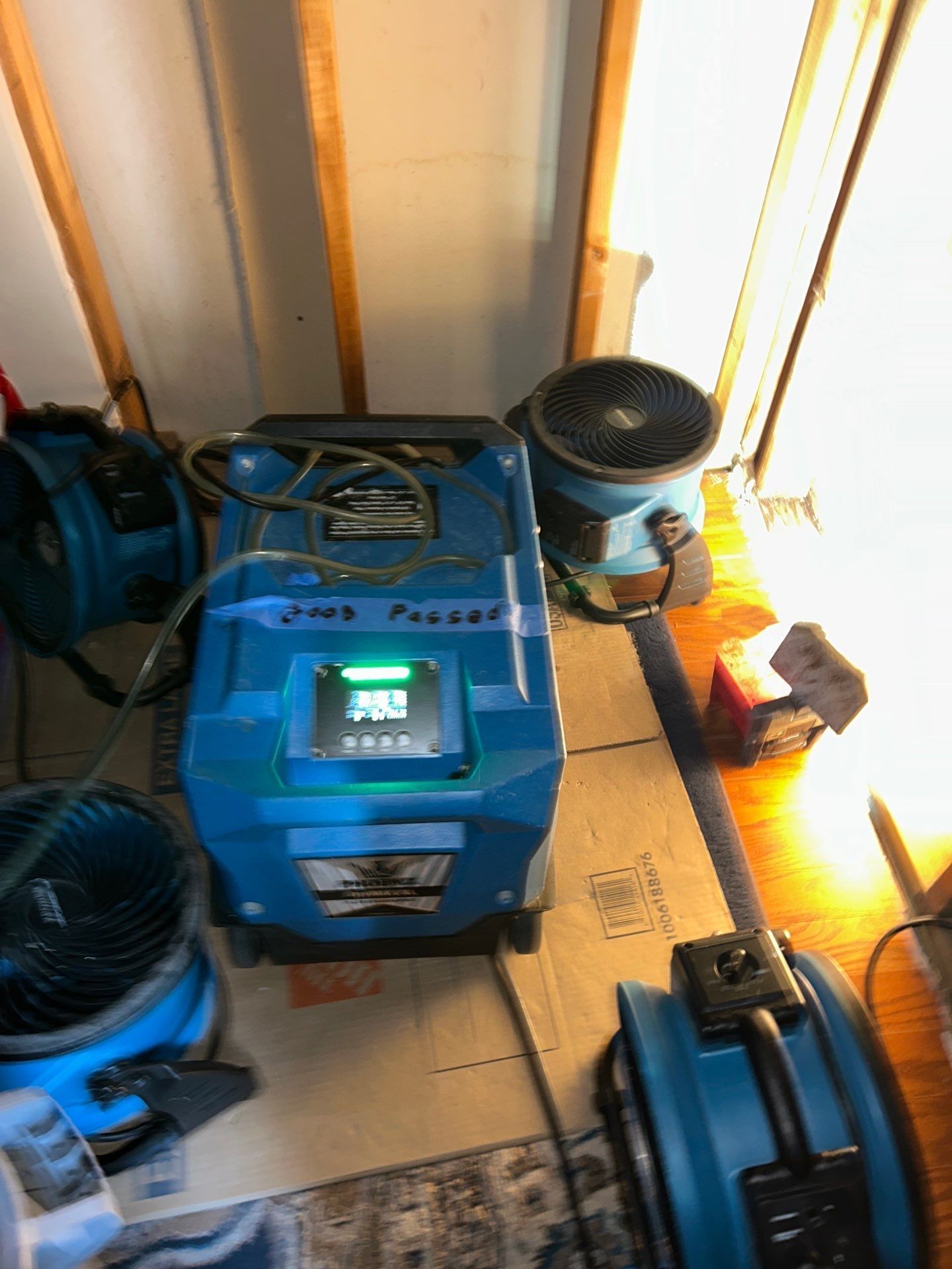 Dehumidifier and air movers drying a room with exposed studs during a mold remediation job in New Jersey