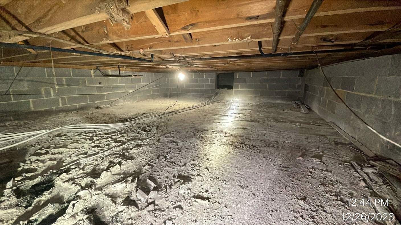 Crawlspace floor treated with antimicrobial powder after sewage cleanup