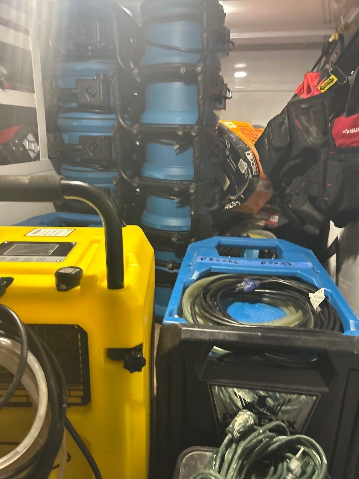 Dehumidifiers and stacked air movers staged for day-one water mitigation