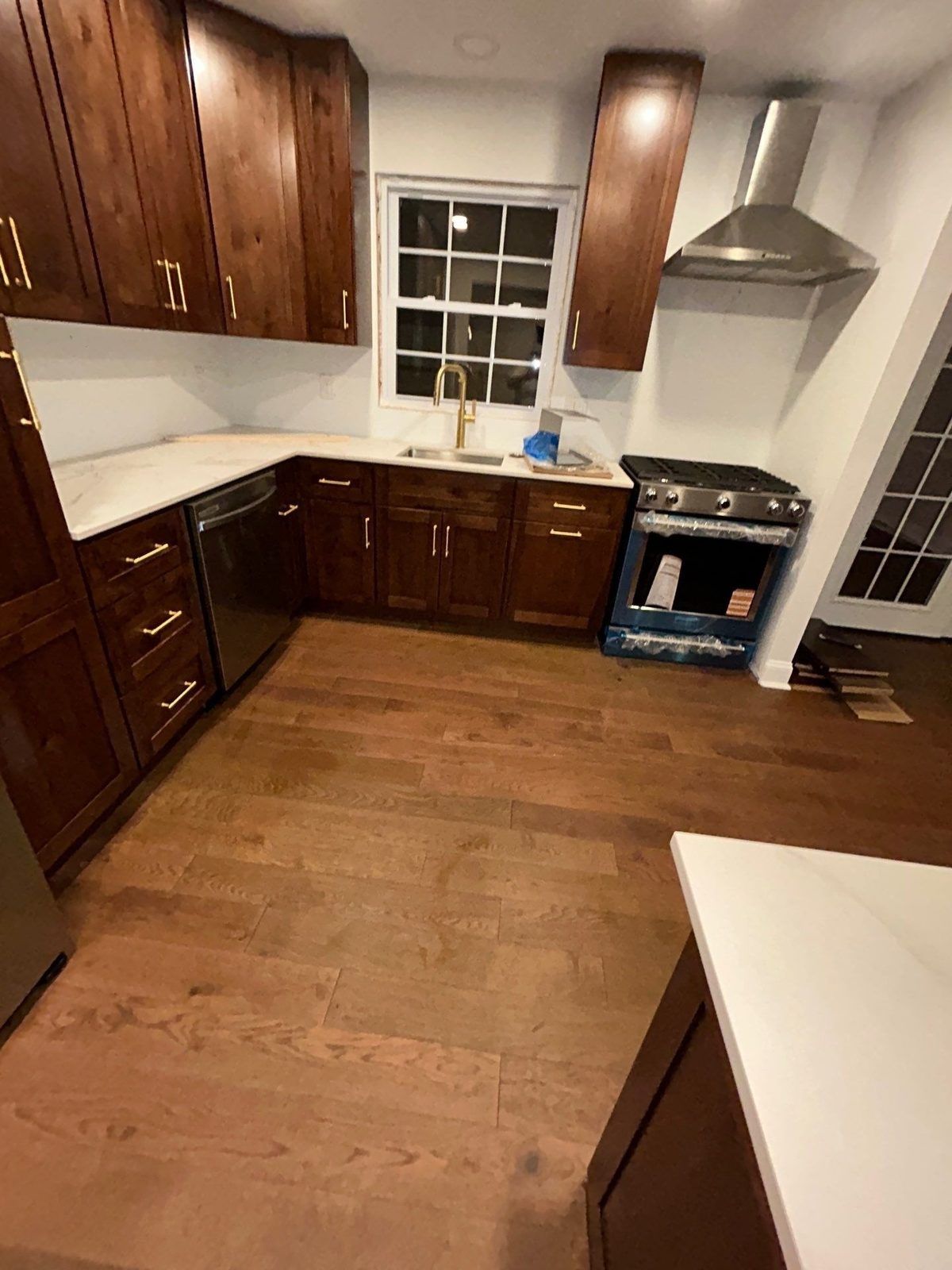 Rebuilt kitchen with new wood cabinets, quartz counters and hardwood floors