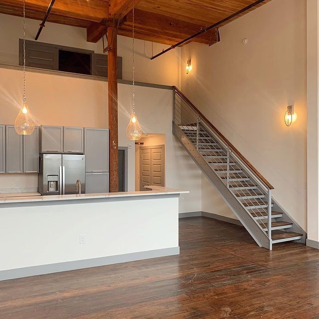 A kitchen with a staircase leading up to the second floor.