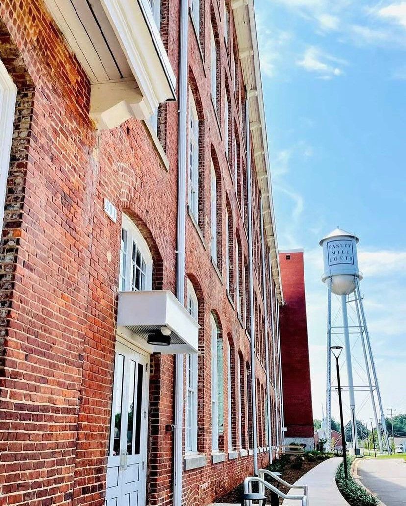 A brick building with a water tower in the background.