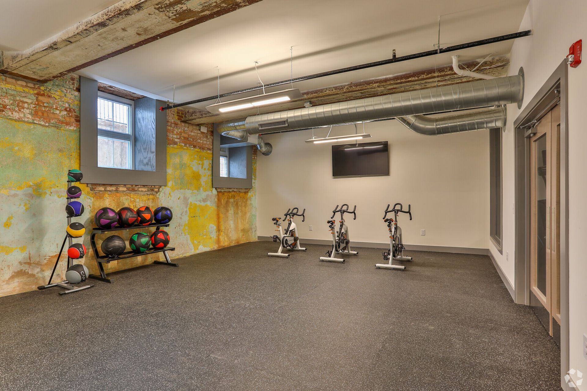 There are a lot of exercise bikes in this room.