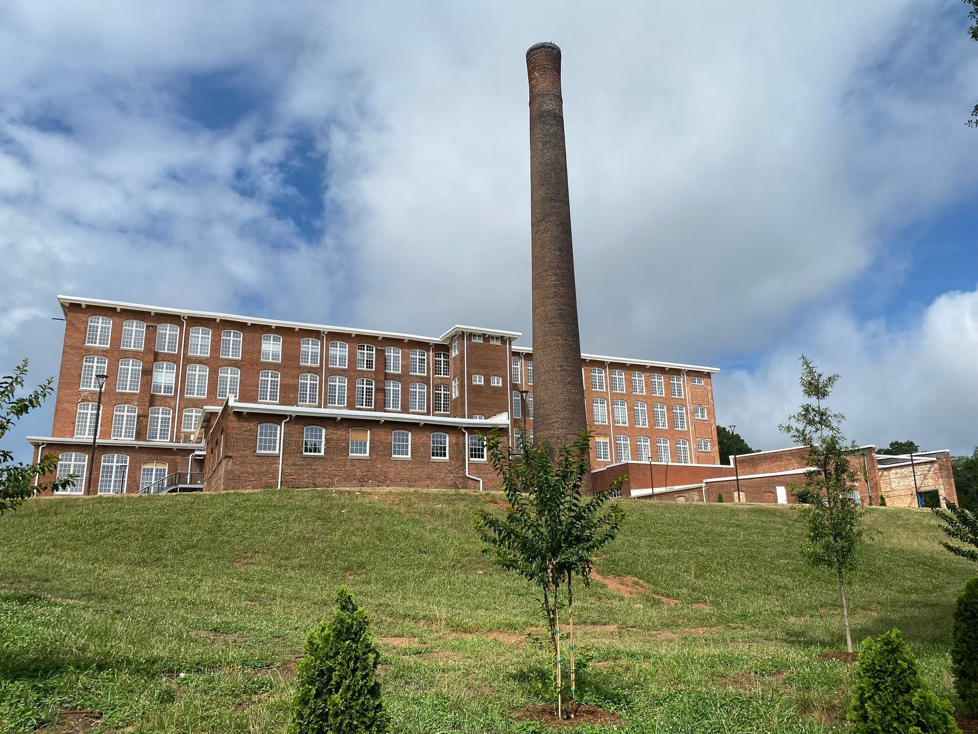 A large brick building with a chimney on top of it.