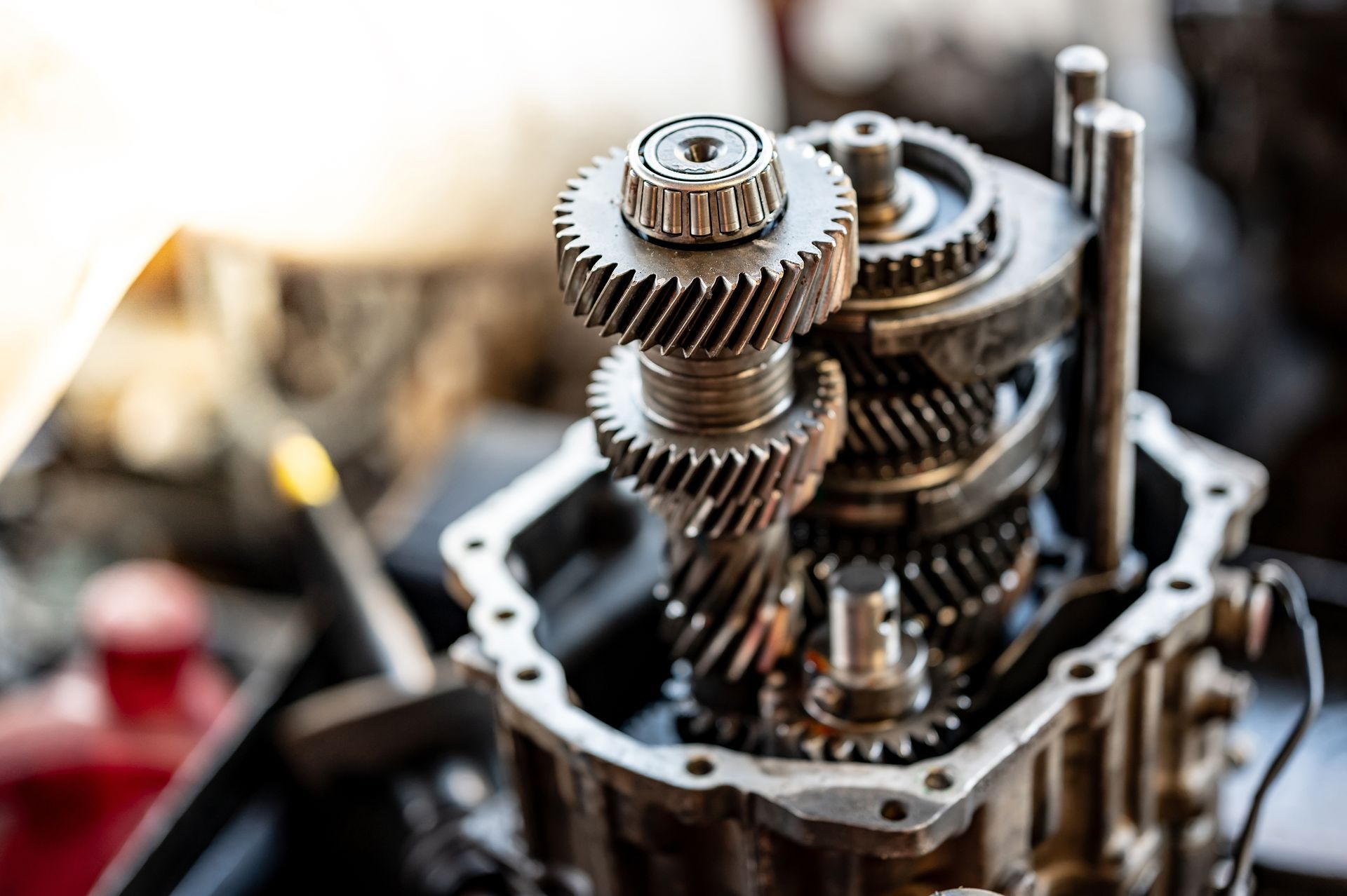 Close-up of gears inside a car transmission, exposed and ready for maintenance, metallic and industrial.