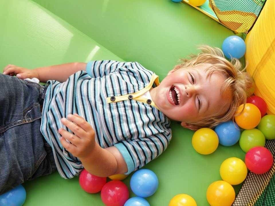 Boy laughing in a jumpy house