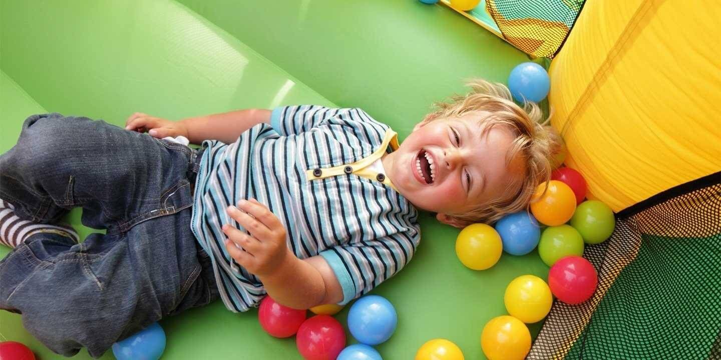 Boy laughing in a jumpy house