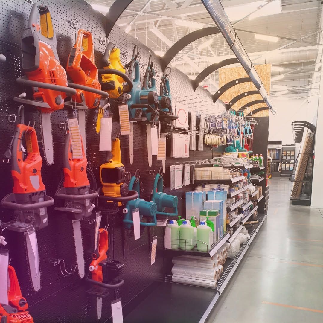 Aisle of colorful hedge trimmers and garden tools displayed in a hardware store