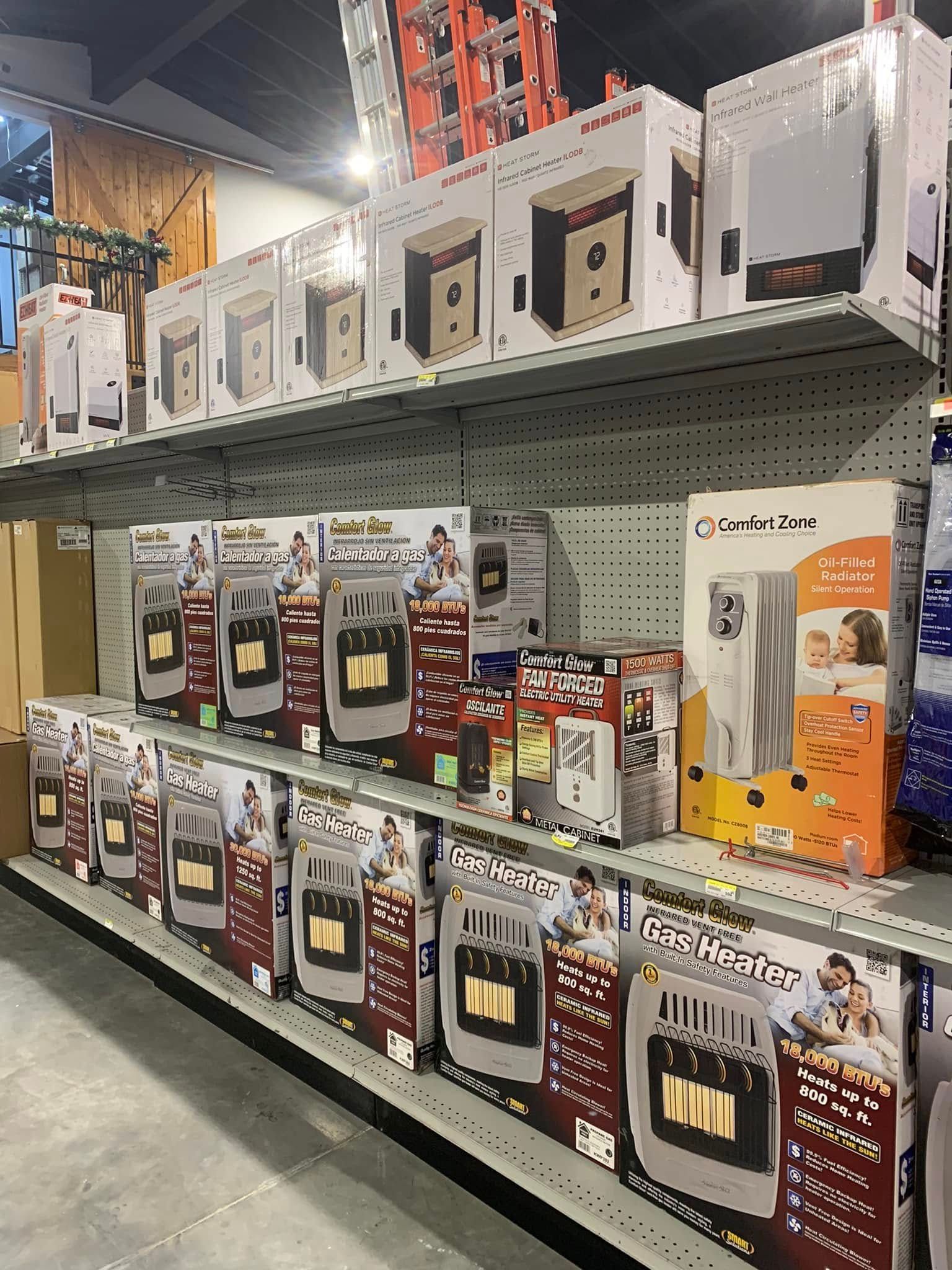 Store aisle with boxed appliances or fans stacked on shelves in a hardware or discount store.