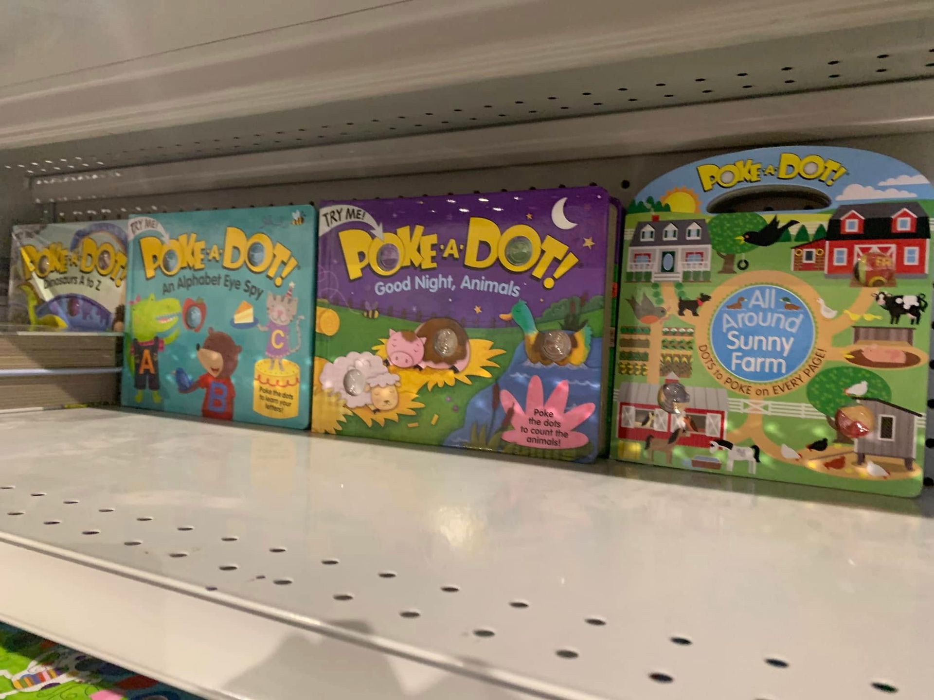 Boxes of Play-Doh on a store shelf, including bright teal, purple, and green packages.