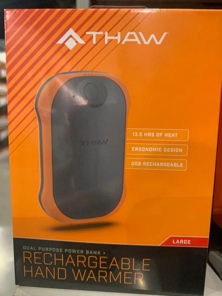 THAW rechargeable hand warmer in orange retail packaging, black device shown front and center