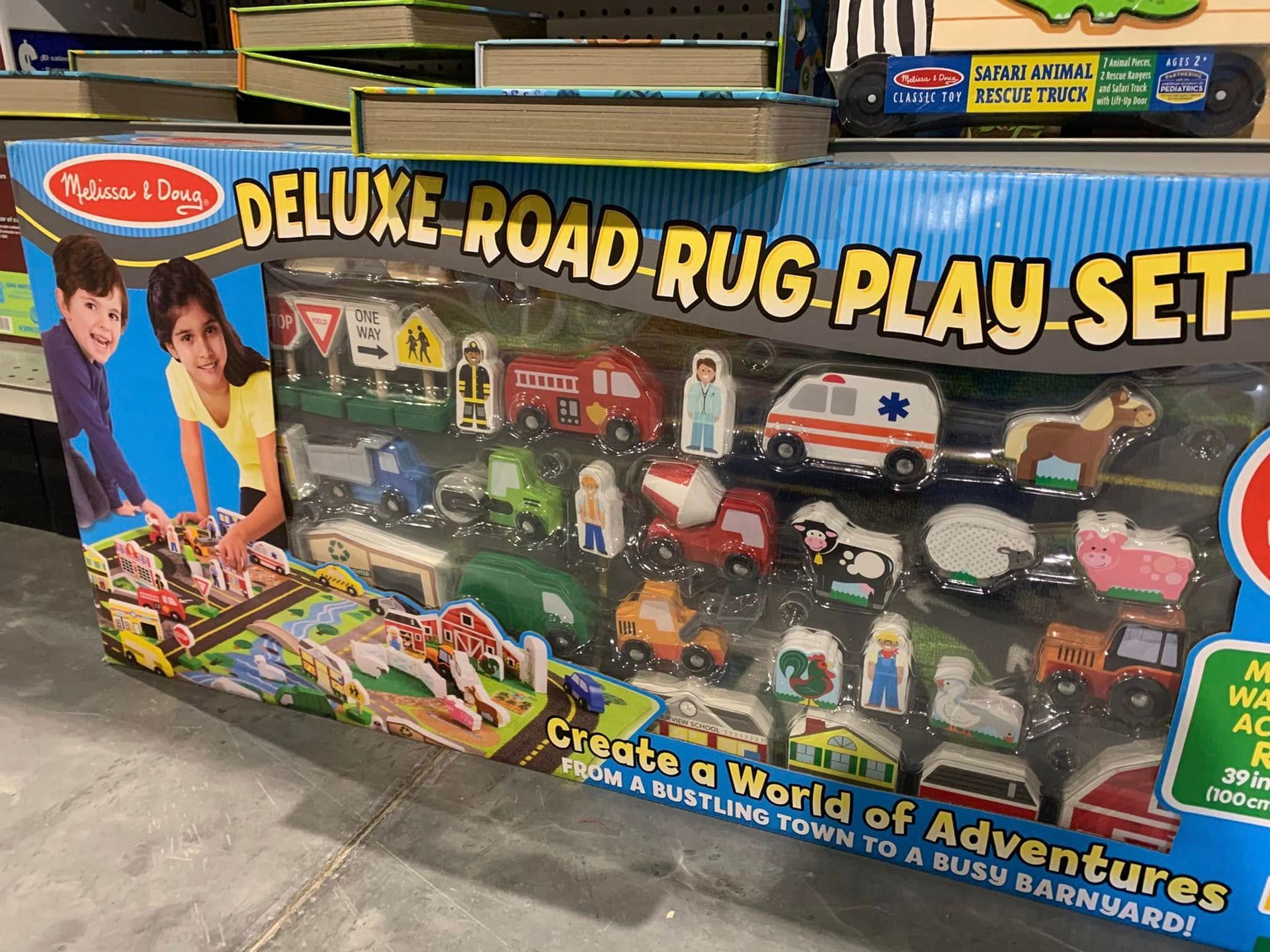 Deluxe road rug play set box with toy cars, buildings, and play mat graphic