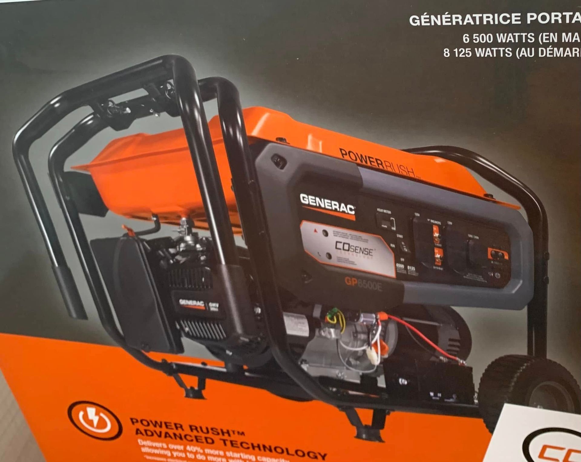 Orange-and-black portable generator with metal frame on product packaging